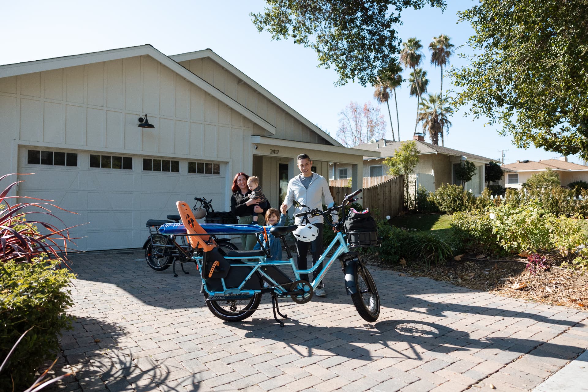 Certified mobile bike mechanic servicing a bicycle in a customer's driveway